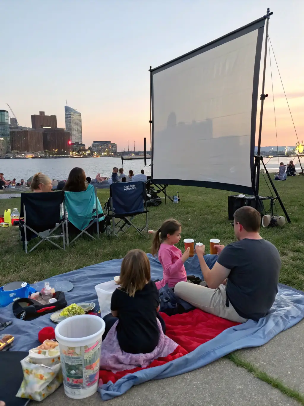 A dynamic image of a film screening in an urban setting, showcasing diverse attendees engaged in watching a thought-provoking film.